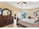 Main bedroom featuring tray ceiling, dark wood furniture, and sliding doors to the pool at 252 Australian Dr, Rotonda West, FL 33947