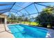 Beautiful screened-in pool surrounded by a spacious patio and well-maintained landscaping. Offers privacy and outdoor enjoyment at 252 Australian Dr, Rotonda West, FL 33947