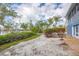 Backyard featuring a sandy area, tropical plants, and a glimpse of the waterfront, creating a private outdoor oasis at 331 Bocilla Dr, Placida, FL 33946