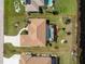 Aerial view of home showcasing a screened-in pool, long driveway and well-maintained yard at 35 Sportsman Pl, Rotonda West, FL 33947