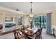 Inviting dining room featuring a wood table with seating for six, bright window, and elegant chandelier at 39 Tournament Rd, Rotonda West, FL 33947
