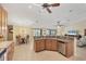 Open kitchen and living area with bar seating and stainless steel dishwasher at 39 Tournament Rd, Rotonda West, FL 33947