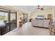 Bright living room with tile floors, ceiling fan, sliding glass doors with outdoor seating and pool view at 39 Tournament Rd, Rotonda West, FL 33947