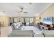 Living room featuring vaulted ceilings, neutral colors, and sliding door access to the lanai at 39 Tournament Rd, Rotonda West, FL 33947