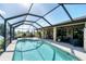 Backyard pool with spacious patio, outdoor seating, and lush landscaping offering a private retreat at 39 Tournament Rd, Rotonda West, FL 33947