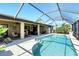 Beautiful in-ground pool with screened enclosure and an outdoor seating and dining area at 39 Tournament Rd, Rotonda West, FL 33947