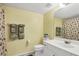 Bright bathroom featuring a shower with seashell pattern curtain at 5725 Greenwood Ave # 8101, North Port, FL 34287