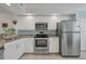 Modern kitchen featuring stainless steel appliances and granite countertops at 5725 Greenwood Ave # 8101, North Port, FL 34287