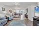 Open concept living room with tile floor, stylish furniture, and decor leading into the dining area at 5725 Greenwood Ave # 8101, North Port, FL 34287