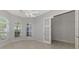 Bedroom with ceiling fan, multiple windows and french doors at 8401 Gateway Ct, Englewood, FL 34224