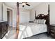 Comfortable bedroom with a four-poster bed, ample closet space, and wood-look tile flooring at 9533 Arnaz Cir, Port Charlotte, FL 33981