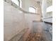 Large tiled walk-in shower with bench and pebble tile floor, offers a spa-like experience at 9533 Arnaz Cir, Port Charlotte, FL 33981