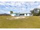 View of the backyard and screened in back patio of a single Gathering home at 10307 Grail Ave, Englewood, FL 34224