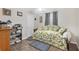 Bedroom with tile floors, a ceiling fan, and a uniquely patterned day bed at 10307 Grail Ave, Englewood, FL 34224