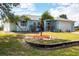 Charming single-story home with lush landscaping, lovely palm trees, and a well-maintained lawn at 10307 Grail Ave, Englewood, FL 34224