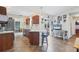 Open kitchen featuring tile floors, a breakfast bar and access to a dining area at 10307 Grail Ave, Englewood, FL 34224