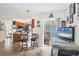 Kitchen with breakfast bar with seating, tiled floor, and access to patio at 10307 Grail Ave, Englewood, FL 34224