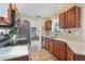 Modern kitchen featuring stainless steel appliances, ample counter space, and warm wood cabinetry at 10307 Grail Ave, Englewood, FL 34224