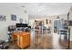 Open concept living room flows into kitchen, featuring tile flooring, and a view of the backyard at 10307 Grail Ave, Englewood, FL 34224