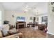 Inviting living room with a vaulted ceiling, a decorative fireplace, and sliding glass doors to the lanai at 10307 Grail Ave, Englewood, FL 34224