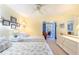 Sunny bedroom with two twin beds, dresser, and access to a private balcony at 11000 Placida Rd # 101, Placida, FL 33946