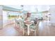 Bright dining room with views and an open concept to the living area and beautiful floral decorations and natural light at 11000 Placida Rd # 101, Placida, FL 33946