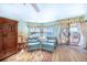 Living room with water views and direct access to the patio, furnished with comfortable seating at 11000 Placida Rd # 101, Placida, FL 33946