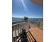 Brick deck overlooking the tranquil water with white railing and potted plants at 11000 Placida Rd # 101, Placida, FL 33946