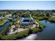 Aerial view of a waterfront home with a screened-in pool and lush landscaping at 1112 Andrews St, Englewood, FL 34224