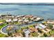 An aerial view of waterfront houses boasting easy access to open waters, surrounded by palm trees at 232 Bahia Vista Dr, Englewood, FL 34223