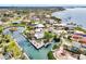 Panoramic aerial view of a neighborhood with waterfront homes, canals, and a central island at 232 Bahia Vista Dr, Englewood, FL 34223