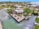 Aerial view of waterfront home with a dock, boat lift, landscaped yard, and canal access to open water at 232 Bahia Vista Dr, Englewood, FL 34223