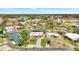 Stunning waterfront property featuring mature trees and lush lawns with detached structure and ample parking at 232 Bahia Vista Dr, Englewood, FL 34223