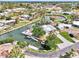 Beautiful aerial view of a waterfront home with a private dock on a tranquil canal with lush landscaping at 232 Bahia Vista Dr, Englewood, FL 34223
