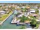 Aerial view of waterfront neighborhood showcasing canals, lush greenery, and central roundabout at 232 Bahia Vista Dr, Englewood, FL 34223