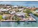 Aerial view featuring a waterfront home with a screened lanai, private dock, and access to open water at 232 Bahia Vista Dr, Englewood, FL 34223