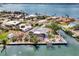 Aerial view of a waterfront home with a screened lanai, dock, and tropical landscaping at 232 Bahia Vista Dr, Englewood, FL 34223