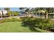 Waterfront property with lush landscaping, a cozy bench and private dock, perfect for enjoying the serene canal views at 232 Bahia Vista Dr, Englewood, FL 34223