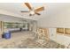 Spacious unfinished basement with a glimpse of outdoor screened area with flooring in need of replacement at 232 Bahia Vista Dr, Englewood, FL 34223