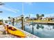 Waterfront property featuring a private dock with boat lift and a vibrant kayak ready for aquatic adventures at 232 Bahia Vista Dr, Englewood, FL 34223
