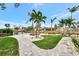 Beautifully landscaped dock and waterfront with lush green lawn and palm trees and canal views at 232 Bahia Vista Dr, Englewood, FL 34223