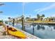 Waterfront property featuring a private dock with boat lift and a vibrant kayak ready for aquatic adventures at 232 Bahia Vista Dr, Englewood, FL 34223