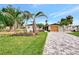 Charming single-story home with a beautifully landscaped front yard, a stone-paved driveway, and a serene atmosphere at 232 Bahia Vista Dr, Englewood, FL 34223