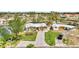 Single-story home with a paved driveway, a two-car garage, and mature landscaping at 232 Bahia Vista Dr, Englewood, FL 34223