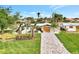 Charming single-story home with a paved driveway, a two-car garage, and mature landscaping at 232 Bahia Vista Dr, Englewood, FL 34223