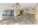 Open-concept living room featuring a ceiling fan and sliding doors to the patio, undergoing renovation at 232 Bahia Vista Dr, Englewood, FL 34223