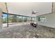 The covered outdoor living area with brick flooring overlooks the pool, undergoing renovation at 232 Bahia Vista Dr, Englewood, FL 34223