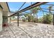 Enclosed pool area with grey brick floor, open pool and metal screening under a bright blue sky at 232 Bahia Vista Dr, Englewood, FL 34223