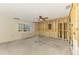 Renovated room with ceiling fan, a window with blinds and exposed wall studs at 232 Bahia Vista Dr, Englewood, FL 34223
