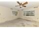 Bright room featuring two windows with blinds, updated ceiling fan, and visible wall framing at 232 Bahia Vista Dr, Englewood, FL 34223